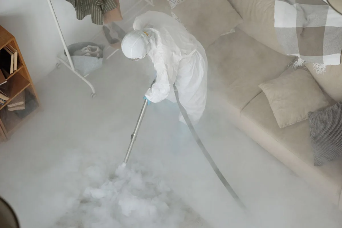 Biohazard cleanup technician in protective equipment, Lake Dallas, TX